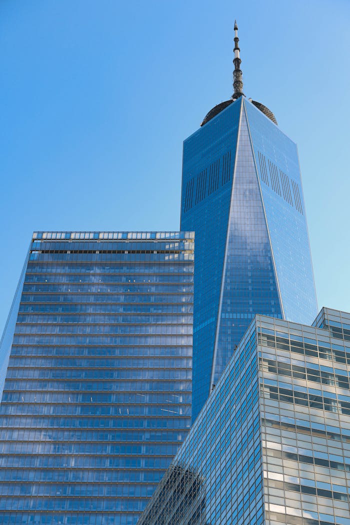 A striking view of One World Trade Center in New York City with a clear blue sky.